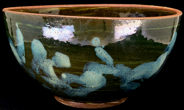 a large green bowl with abstract nuka glaze design