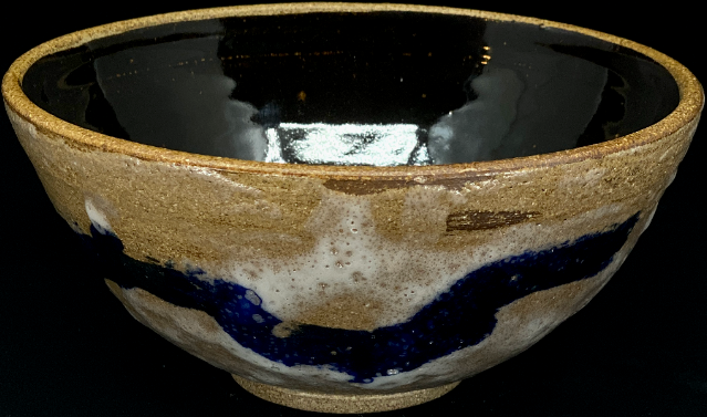 a stoneware bowl with a translucent white glaze and a single cobalt stripe.
